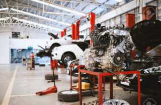 196907846-mechanic-working-car-maintenance-with-soft-focus-and-over-light-in-the-background